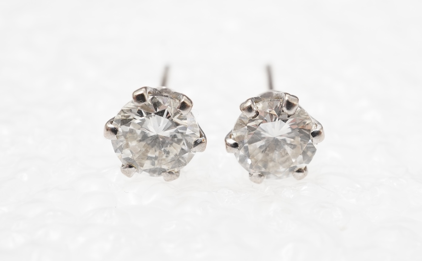 A pair of diamond stud earrings